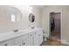Bright primary bathroom with double sinks, a large mirror, and a walk-in closet at 21907 Torrence Chapel Rd, Cornelius, NC 28031