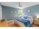 Comfortable bedroom with blue accent wall, hardwood floors, and natural light at 21907 Torrence Chapel Rd, Cornelius, NC 28031