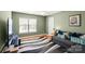 Spacious bedroom featuring green walls, hardwood floors, and natural light at 21907 Torrence Chapel Rd, Cornelius, NC 28031