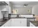 Close up of the modern kitchen with white cabinets, dark countertops, and stainless steel appliances at 21907 Torrence Chapel Rd, Cornelius, NC 28031
