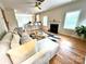 Bright and open living room with a fireplace, large couch, open to kitchen and breakfast area at 21907 Torrence Chapel Rd, Cornelius, NC 28031