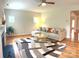 Spacious living room featuring hardwood floors, a cozy couch, area rug and plenty of natural light at 21907 Torrence Chapel Rd, Cornelius, NC 28031