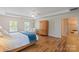 Bright main bedroom featuring tray ceilings, a ceiling fan, and a large wardrobe at 21907 Torrence Chapel Rd, Cornelius, NC 28031