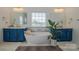 Luxurious bathroom with a freestanding tub, dual vanities, and ample natural light at 2380 Fairport Se Dr, Concord, NC 28025