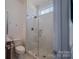 Elegant bathroom with a glass-enclosed shower, subway tile, and marble flooring at 2380 Fairport Se Dr, Concord, NC 28025