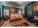 Bedroom showcasing a four-poster bed, stylish lighting, and comfortable sitting area at 2380 Fairport Se Dr, Concord, NC 28025