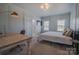 Bright bedroom featuring a desk, large windows, and soothing, light green walls at 2380 Fairport Se Dr, Concord, NC 28025