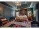 Spacious bedroom featuring a four-poster bed, hardwood floors, and ample natural light at 2380 Fairport Se Dr, Concord, NC 28025