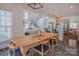 Dining area with rustic wood table and modern light fixture at 2380 Fairport Se Dr, Concord, NC 28025