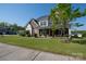 Inviting two-story home featuring a covered porch, well-manicured lawn, and mature landscaping at 2380 Fairport Se Dr, Concord, NC 28025