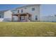 Back exterior view of home with covered patio and large lawn at 2380 Fairport Se Dr, Concord, NC 28025