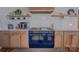Gourmet kitchen with blue stove, custom cabinetry, and modern appliances at 2380 Fairport Se Dr, Concord, NC 28025
