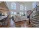 Bright and airy living room with soaring windows, modern chandelier, and cozy fireplace at 2380 Fairport Se Dr, Concord, NC 28025