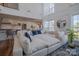 Bright, open living room featuring a large white sofa and tall ceilings at 2380 Fairport Se Dr, Concord, NC 28025