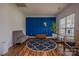 Cozy office space featuring a blue accent wall, stylish lamp, and hardwood flooring at 2380 Fairport Se Dr, Concord, NC 28025