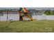 Backyard playground with swings, slide, climbing nets, and storage shed at 2380 Fairport Se Dr, Concord, NC 28025