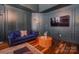 Cozy sitting area in bedroom with a blue sofa, modern lighting, and hardwood floors at 2380 Fairport Se Dr, Concord, NC 28025