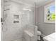 Bright, modern bathroom with marble-style tiling and a glass-enclosed shower at 241 Wakefield Dr # C, Charlotte, NC 28209