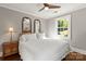 Cozy bedroom with warm light, bedside table, and window at 241 Wakefield Dr # C, Charlotte, NC 28209