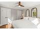 Inviting bedroom with ceiling fan, natural light, and closet doors at 241 Wakefield Dr # C, Charlotte, NC 28209