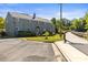 Charming rear exterior view with a bridge access, well-maintained lawn, and surrounding greenery at 241 Wakefield Dr # C, Charlotte, NC 28209