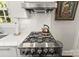 Close-up of a modern stainless steel range top and a window-lit countertop at 241 Wakefield Dr # C, Charlotte, NC 28209