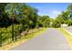Well-maintained asphalt walking path lined with trees and greenery at 241 Wakefield Dr # C, Charlotte, NC 28209