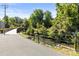 Picturesque walking trail, bordered by lush greenery and a tranquil stream, offers residents a refreshing outdoor experience at 241 Wakefield Dr # C, Charlotte, NC 28209