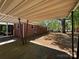 A covered patio overlooks the back yard of this brick house at 2703 34Th Street Ne Pl, Hickory, NC 28601