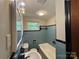 The bathroom has blue tile, black trim, a unique light fixture, and a window at 2703 34Th Street Ne Pl, Hickory, NC 28601
