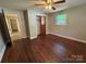 This bedroom has hardwood floors, a window, a closet, and a ceiling fan with light at 2703 34Th Street Ne Pl, Hickory, NC 28601