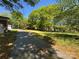 View of long driveway leading up to the side of house and large treed front yard at 2703 34Th Street Ne Pl, Hickory, NC 28601