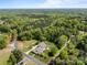 Aerial view of the property surrounded by lush forest, with a long driveway and well-maintained landscaping at 3008 Gantt St, Salisbury, NC 28146