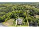 Aerial view outlining the property, showcasing the house, driveway, garden, and surrounding trees for privacy at 3008 Gantt St, Salisbury, NC 28146