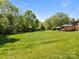 Expansive backyard featuring lush green grass, a play set, and a gazebo with a hot tub, perfect for outdoor fun at 3008 Gantt St, Salisbury, NC 28146