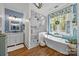 Elegant bathroom featuring a stand-alone tub, glass-enclosed shower, and a blue accent wall at 3008 Gantt St, Salisbury, NC 28146