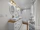 Bright bathroom with double vanity, vessel sinks, hardwood floors, and walk-in shower at 3008 Gantt St, Salisbury, NC 28146