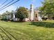 Exterior view of the home showing the stone facade, chimney, and lush lawn at 3008 Gantt St, Salisbury, NC 28146