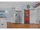 Modern kitchen featuring stainless steel appliances, a decorative wooden sliding pantry door, and blue textured walls at 3008 Gantt St, Salisbury, NC 28146