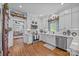 Well-lit kitchen features white cabinets, stainless appliances, and hardwood floors at 3008 Gantt St, Salisbury, NC 28146