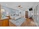 Main bedroom with a ceiling fan, a large rug, and blue textured walls for a bright and airy feel at 3008 Gantt St, Salisbury, NC 28146