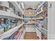 Walk-in pantry with white shelves, ample storage space, and decorative curtains under the bottom shelves at 3008 Gantt St, Salisbury, NC 28146