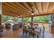 Spacious covered patio with wood floors, ceiling fans, comfortable seating and dining area, perfect for outdoor relaxation at 3008 Gantt St, Salisbury, NC 28146