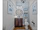 Stylish powder room featuring blue textured wallpaper, updated lighting, framed artwork and hardwood floors at 3008 Gantt St, Salisbury, NC 28146