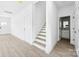 Entryway boasts neutral walls, modern staircase, and seamless access to the bathroom at 3048 Goble St, Gastonia, NC 28056