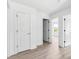 Neutral colored hallway with doors, casings, baseboards and wood-look flooring at 3048 Goble St, Gastonia, NC 28056