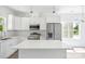 Bright kitchen features stainless appliances, white cabinets, island and light filled dining area at 3048 Goble St, Gastonia, NC 28056