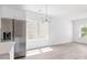 This kitchen has stainless appliances, white cabinets and island, flowing into a dining area at 3048 Goble St, Gastonia, NC 28056
