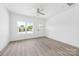 Bright, open living room features neutral walls, large window, and modern wood-look floors at 3048 Goble St, Gastonia, NC 28056