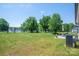 Large backyard with black fence, patio seating area, and mature trees for a private outdoor space at 3121 Suffolk Dr, Shelby, NC 28152